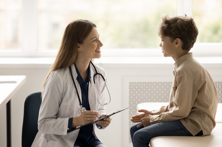 Child talking to his doctor during a pediatric clinical trial