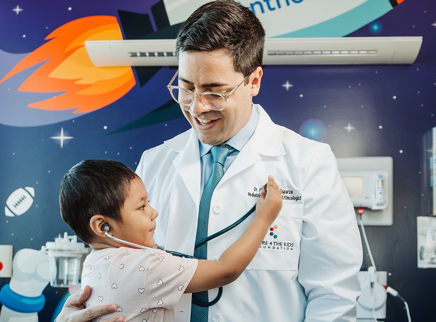 C4K's Dr. Raul with a pediatric cancer patient