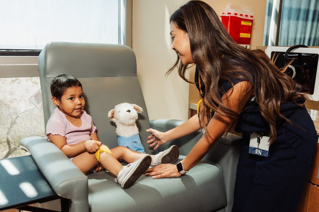 A pediatric oncology nurse with a patient at Cure 4 The Kids Foundation