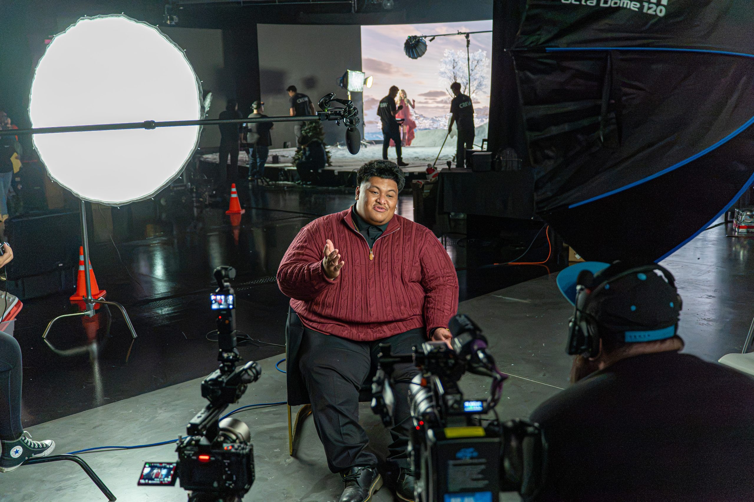 Samoan Silkk gives an on-camera interview while the crew resets the stage behind him