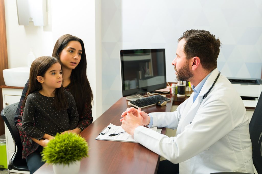 A doctor speaks with a rare disease family