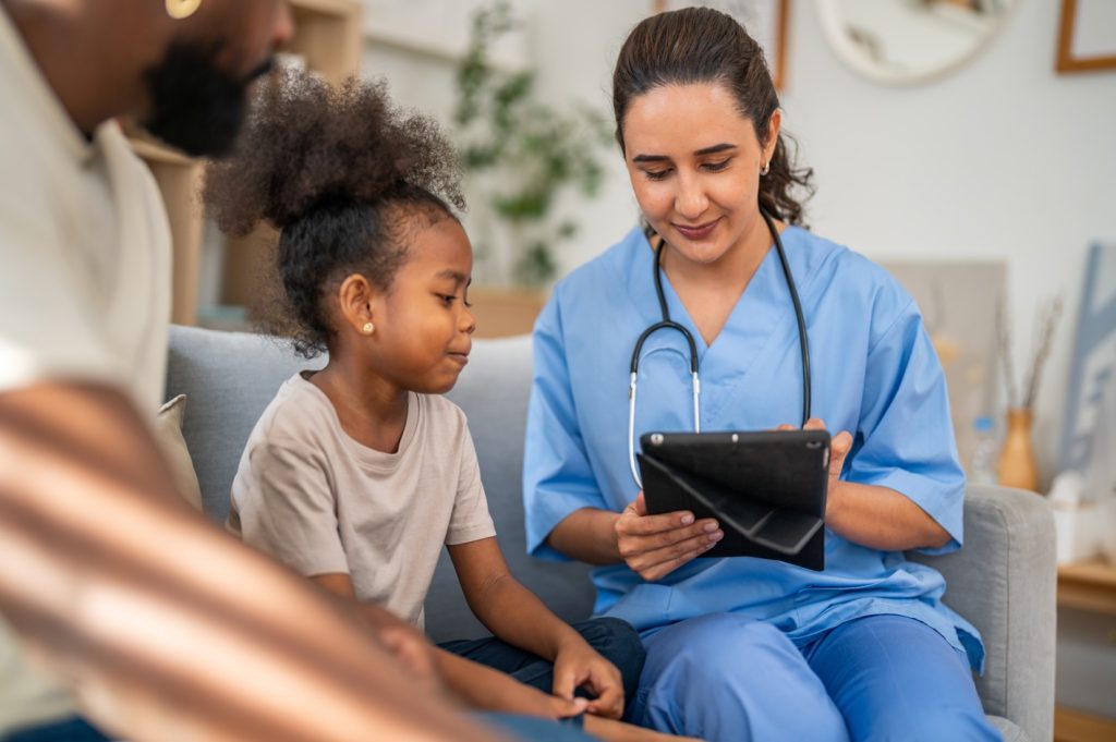 A nurse holds a tablet with a rare disease patient